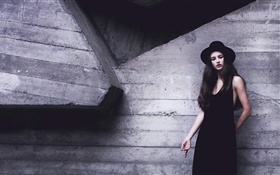 黑色连衣裙的女孩，帽子，墙